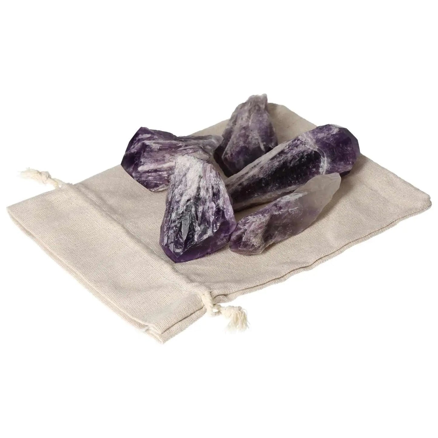 Amethyst Point L crystals on a beige pouch, highlighting their deep purple hues and natural beauty from Sylvia Crystals.