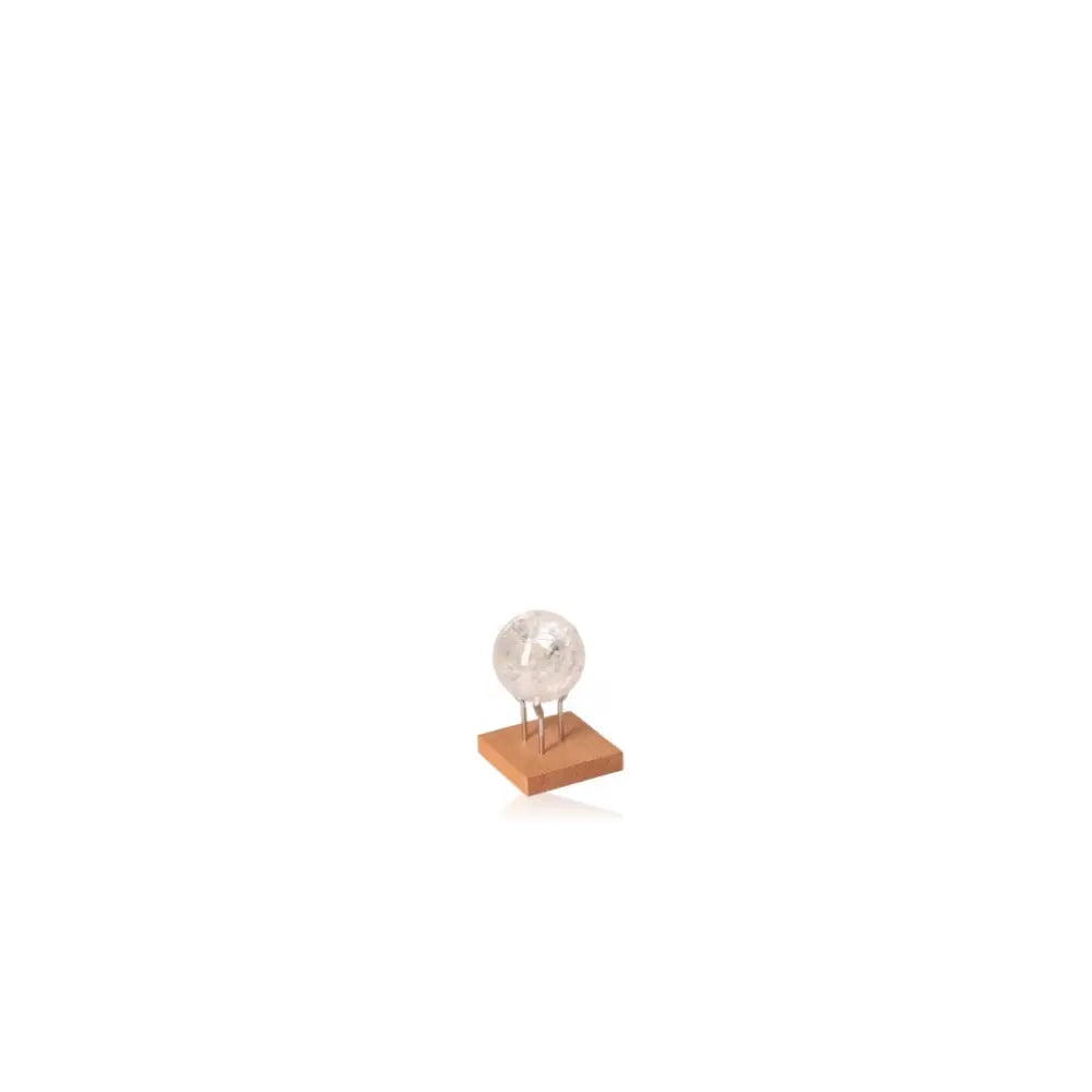 Lemurian Quartz Sphere on a wooden stand, an elegant energy amplifier and mystical decor piece.