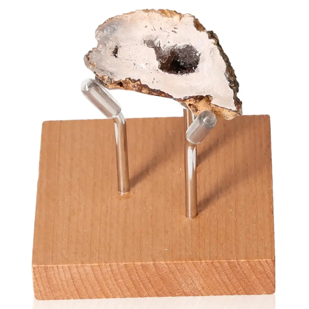 Mini Agate Geode on a wooden stand showcasing its natural beauty and energy-balancing properties.