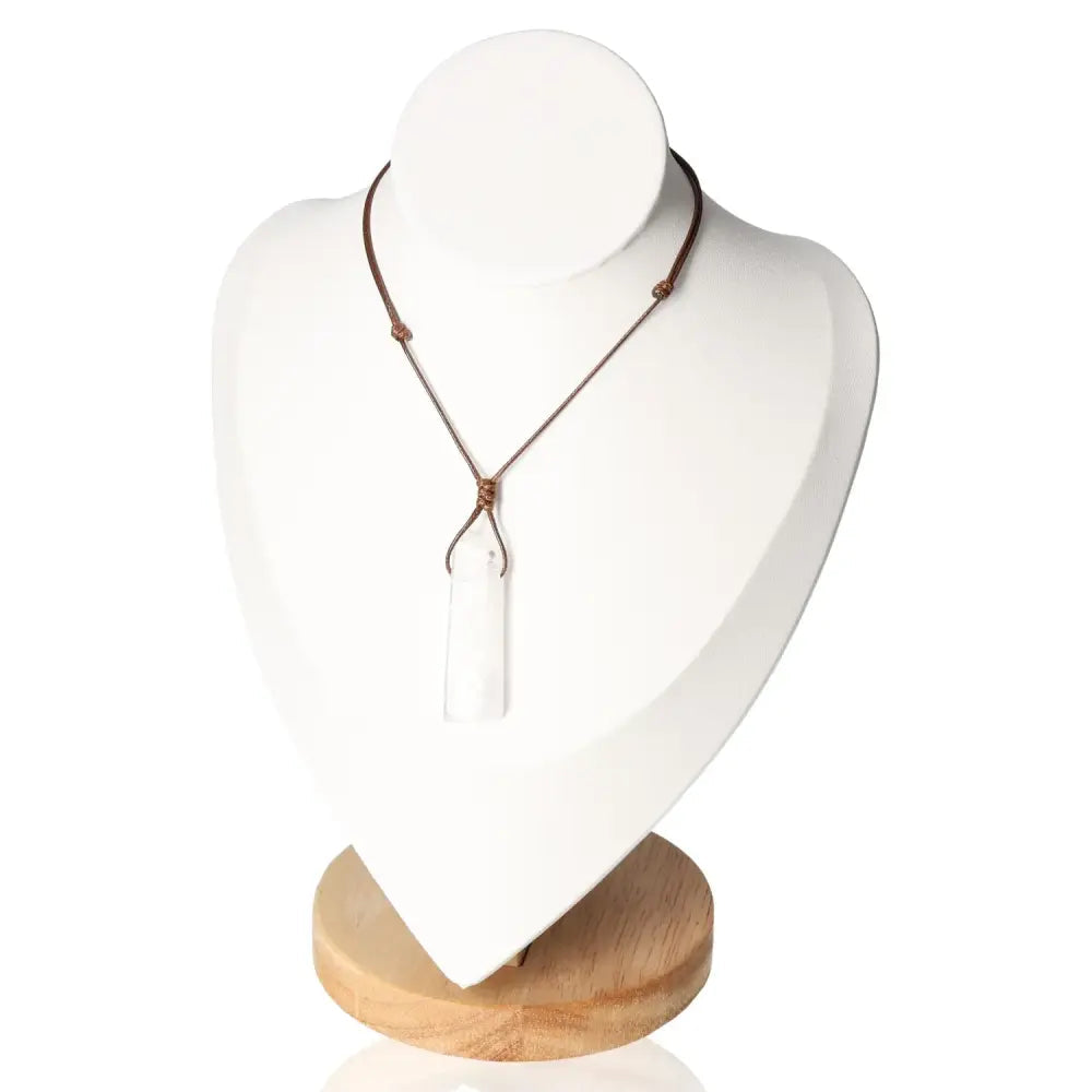 Clear quartz boho necklace with brown cord on display stand, showcasing tranquil and elegant bohemian style jewelry.