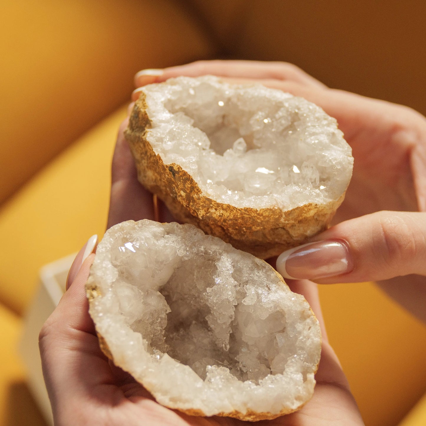 Hands holding a sparkling quartz geode, part of the Abundant Love Gift Box for Valentine's Day, symbolizing love and abundance.
