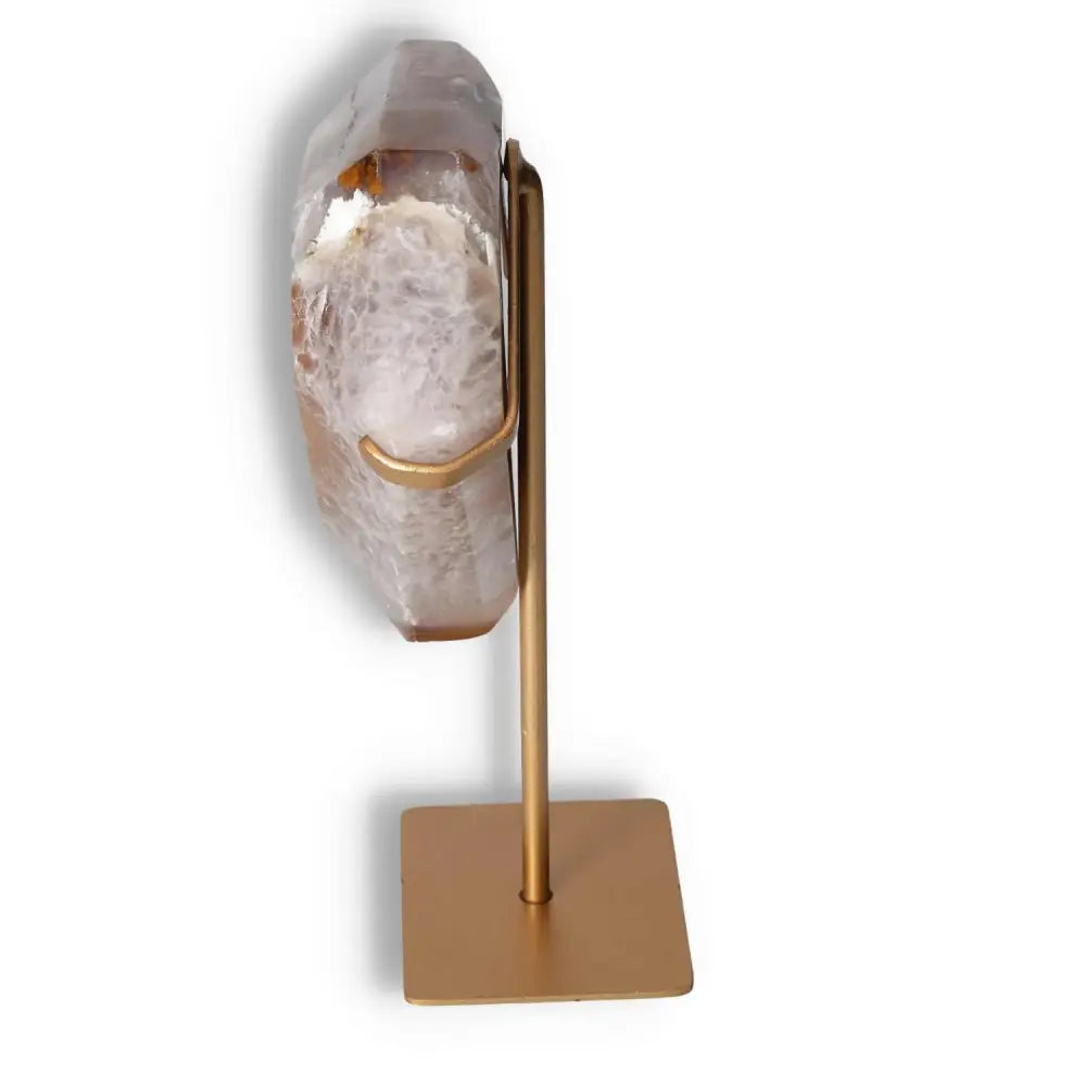 Side view of a polished agate decoration with stand showcasing intricate natural patterns and delicate crystalline formations.