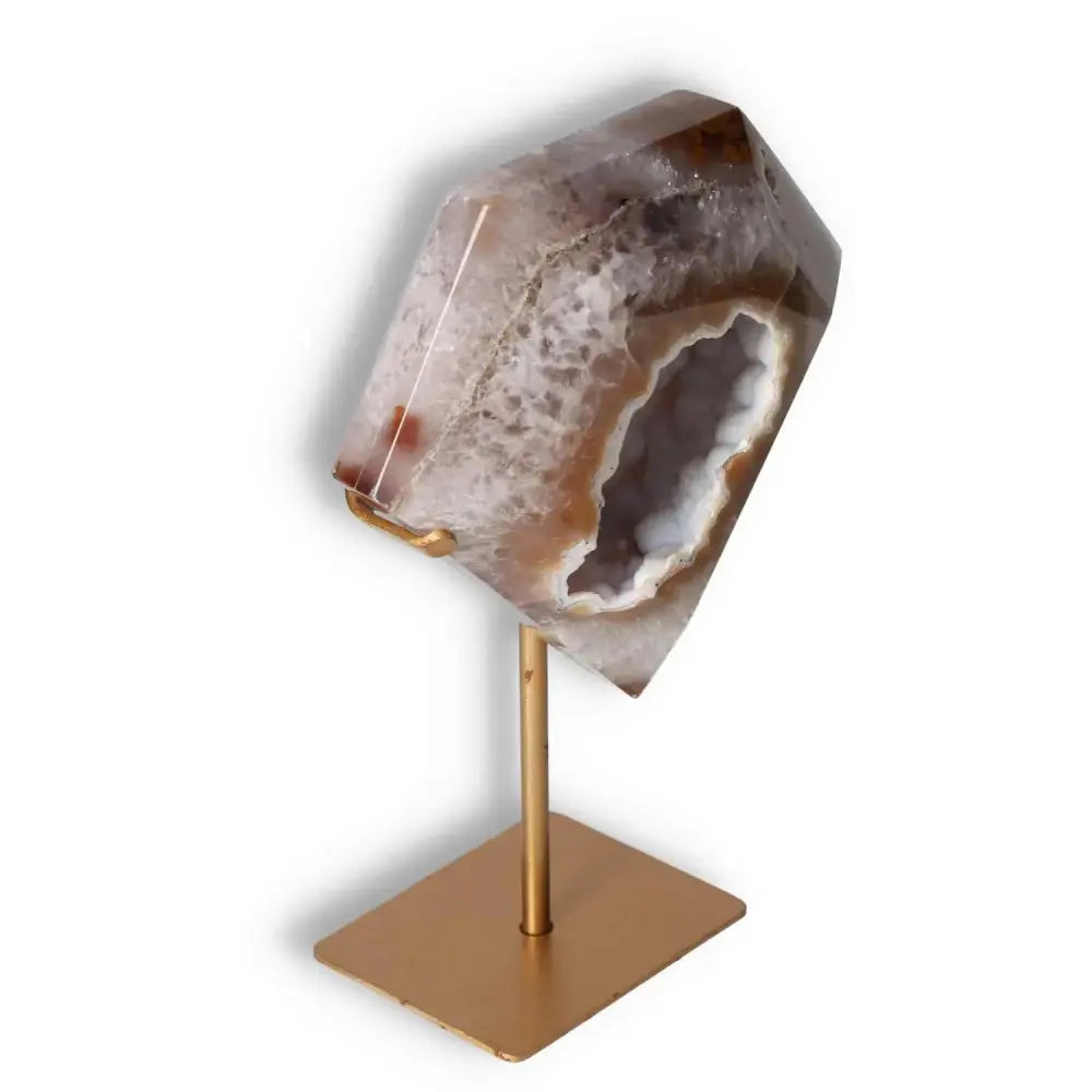 Agate decoration with stand showcasing natural patterns and veining, highlighting its crystalline and elegant sculpture on a gold base.