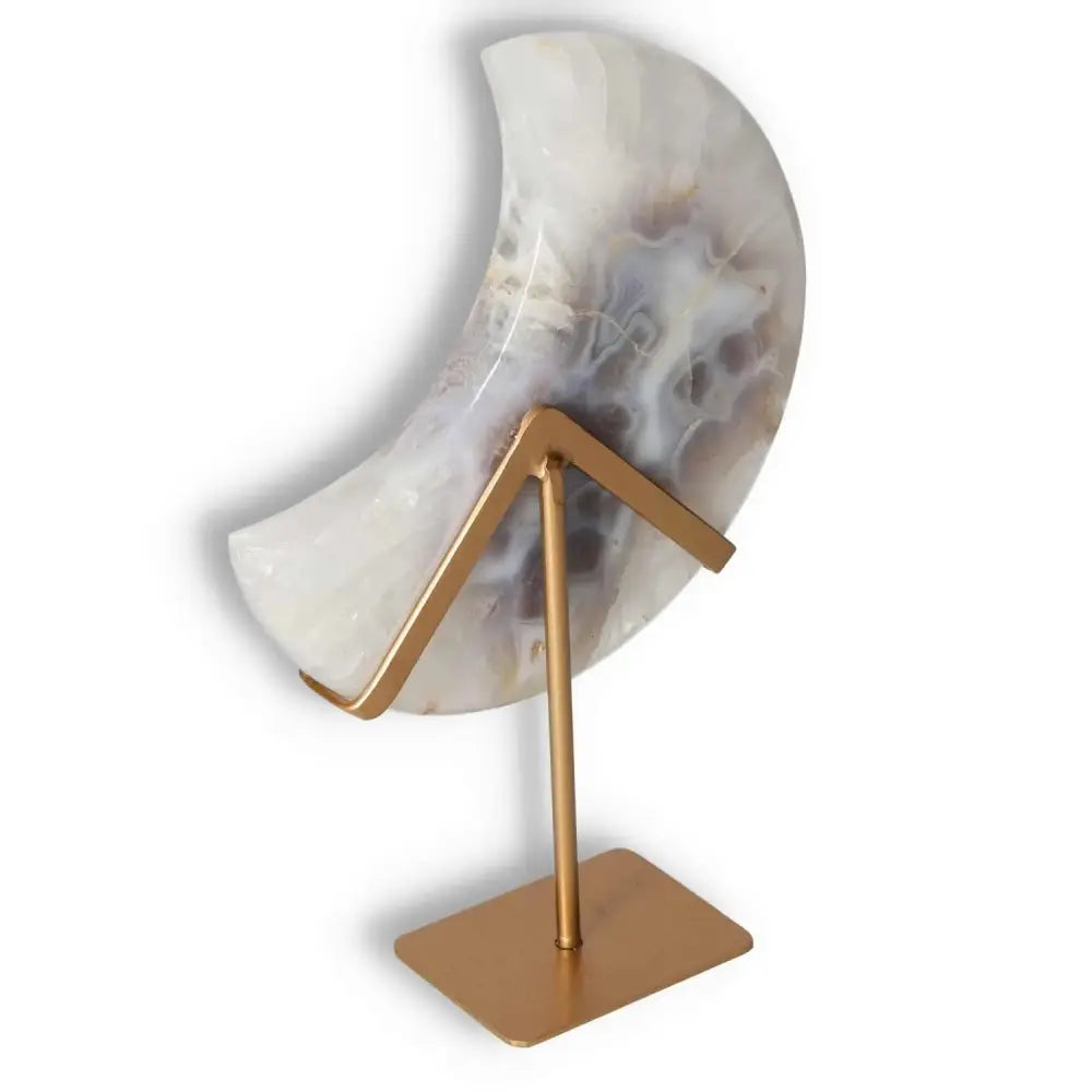 Agate lunar crescent sculpture on a gold stand showcasing translucent swirls and natural geode center, perfect for ethereal home decor.