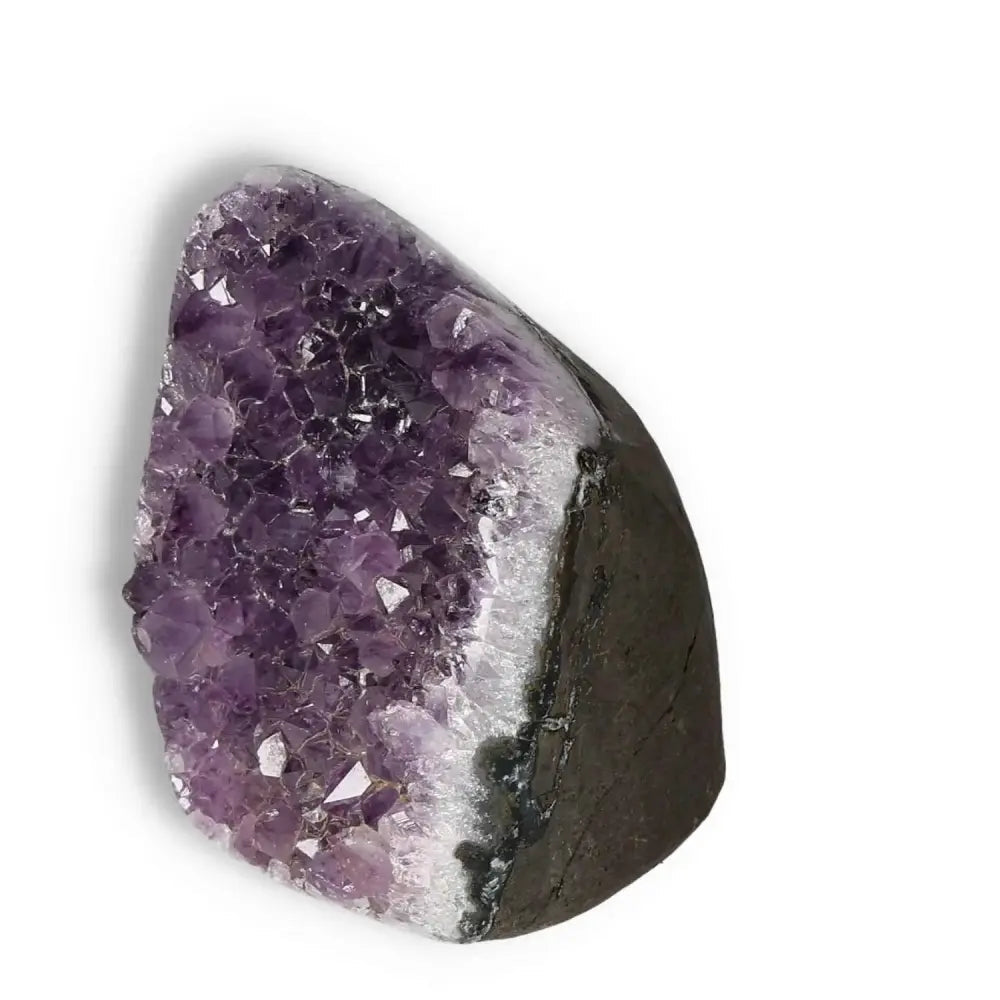 Amethyst Cut Base Geode from Sylvia Crystals' collection, showcasing natural purple hues and sparkling crystal formations.