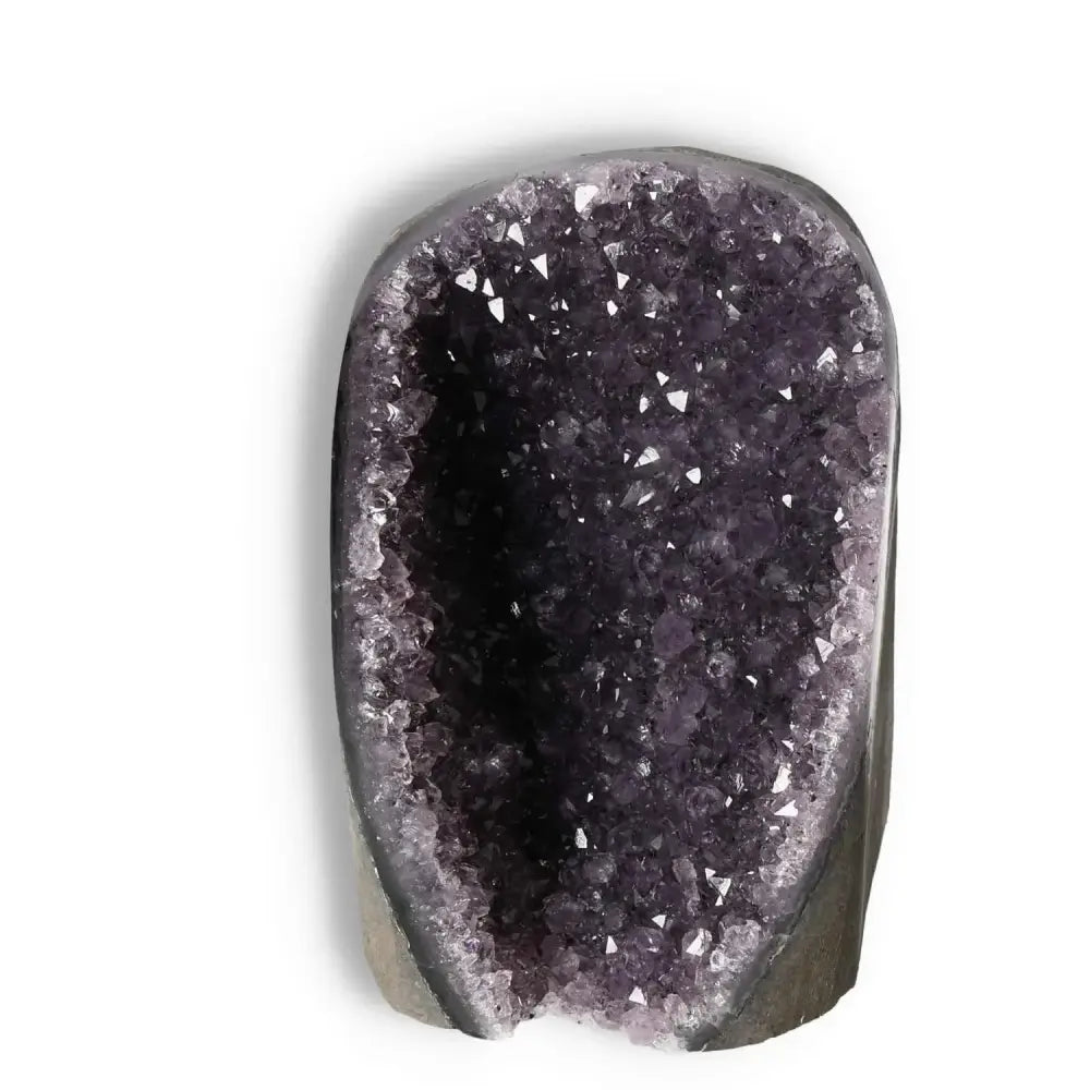 Amethyst Cut Base Geode by Sylvia Crystals, a luxurious decorative piece symbolizing elegance and spirituality in living spaces.