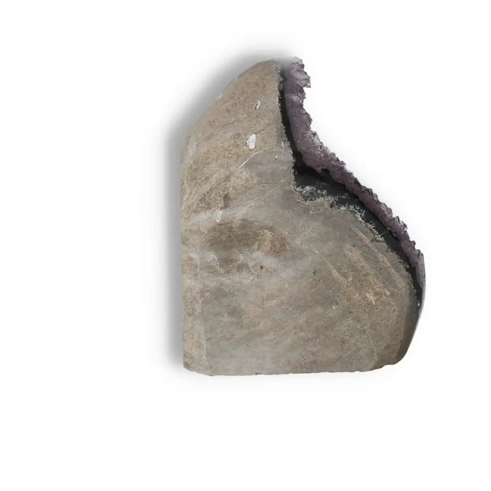 Side view of a handcrafted Amethyst Cut Base Geode by Sylvia Crystals, showcasing its unique texture and natural elegance.