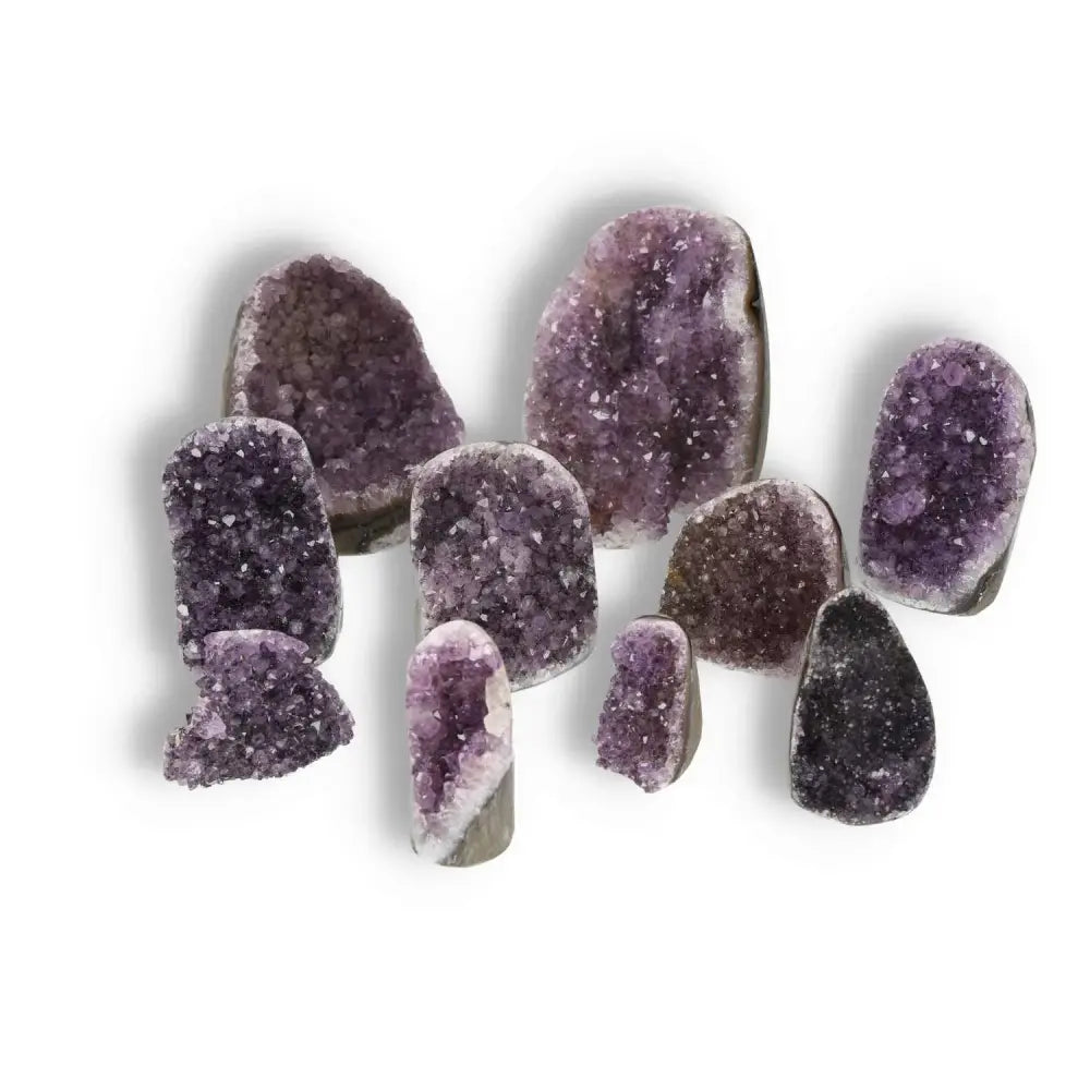 Assorted amethyst cut base geodes ranging from 0.1-1 kg, showcasing vibrant purple crystals, ideal for spiritual wellness and decor.