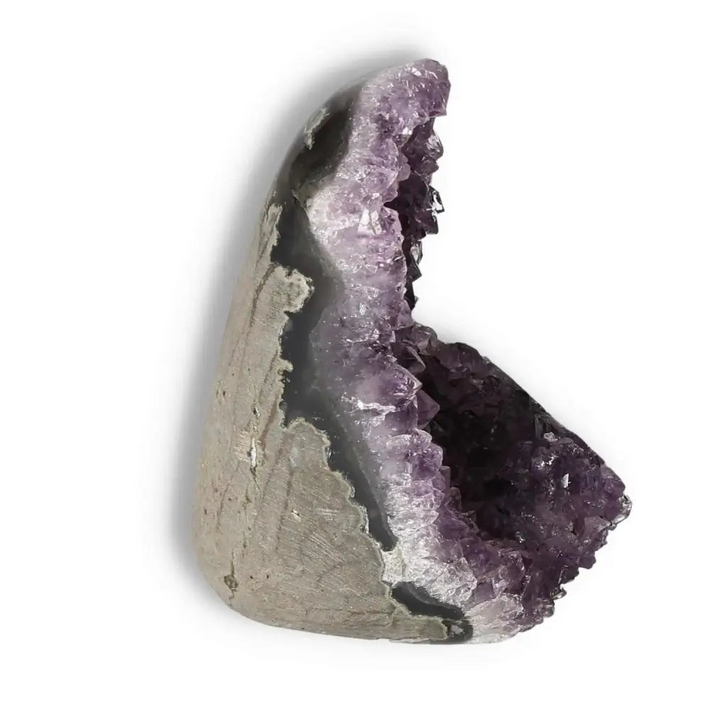 Amethyst cut base geode from Sylvia Crystals, renowned for calming properties and energy enhancement, showcasing purple crystal formation.