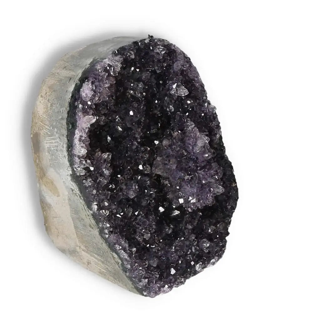 Amethyst cut base geode by Sylvia Crystals, showcasing luxury and spiritual elegance with a polished, shimmering purple surface.