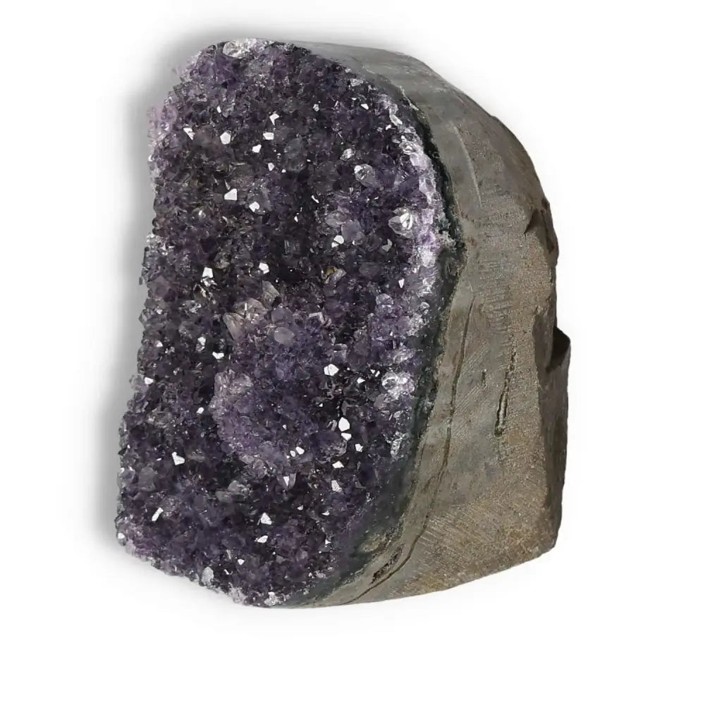 Amethyst cut base geode from Sylvia Crystals, showcasing luxury and spiritual elegance with a natural shimmering purple finish.