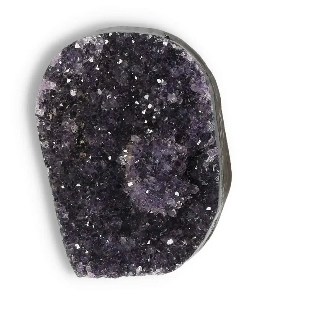 Amethyst cut base geode from Sylvia Crystals showcasing sparkling purple crystals, ideal for enhancing spiritual or living spaces.