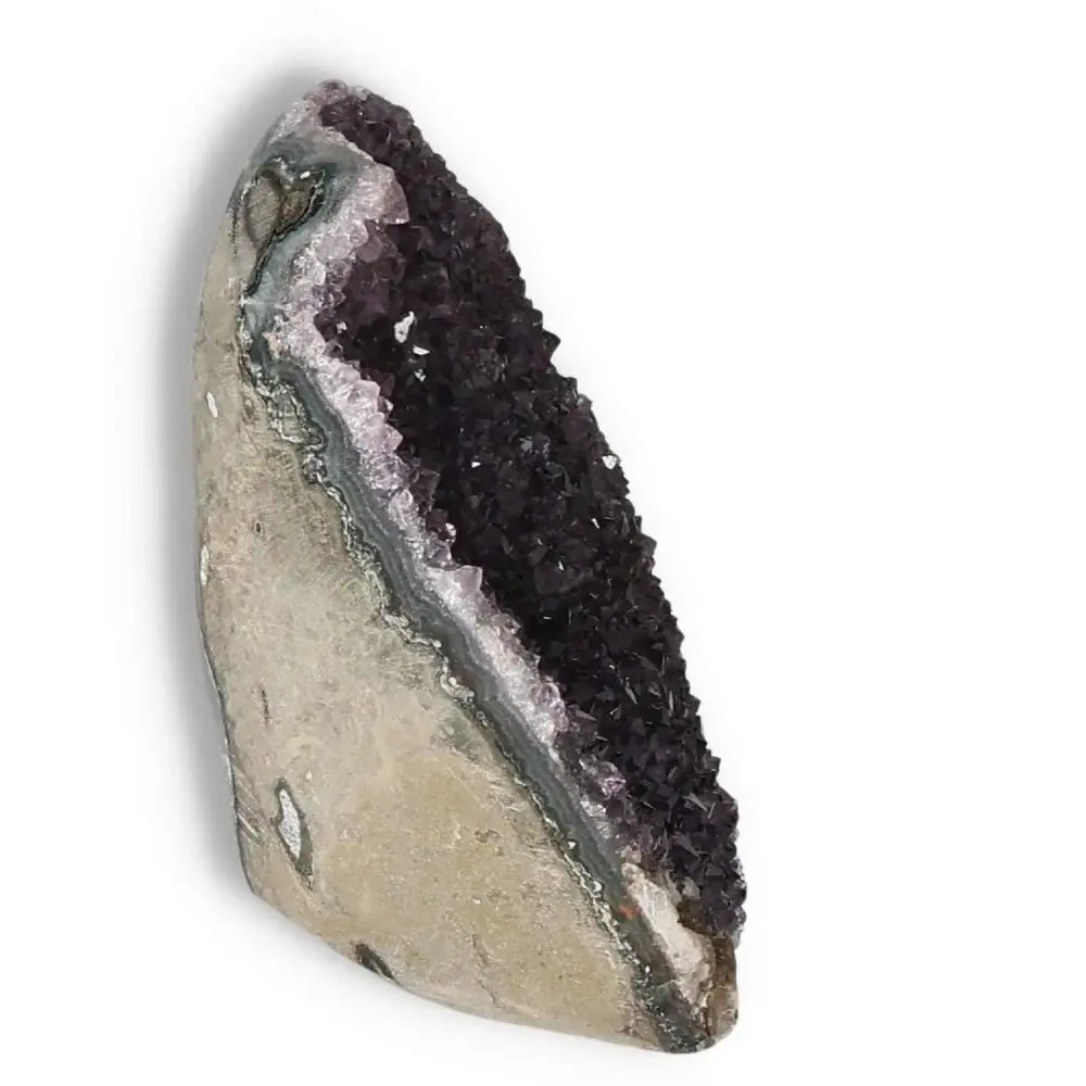 Amethyst cut base geode with purple crystals from Sylvia Crystals, known for stress reduction and promoting balance.
