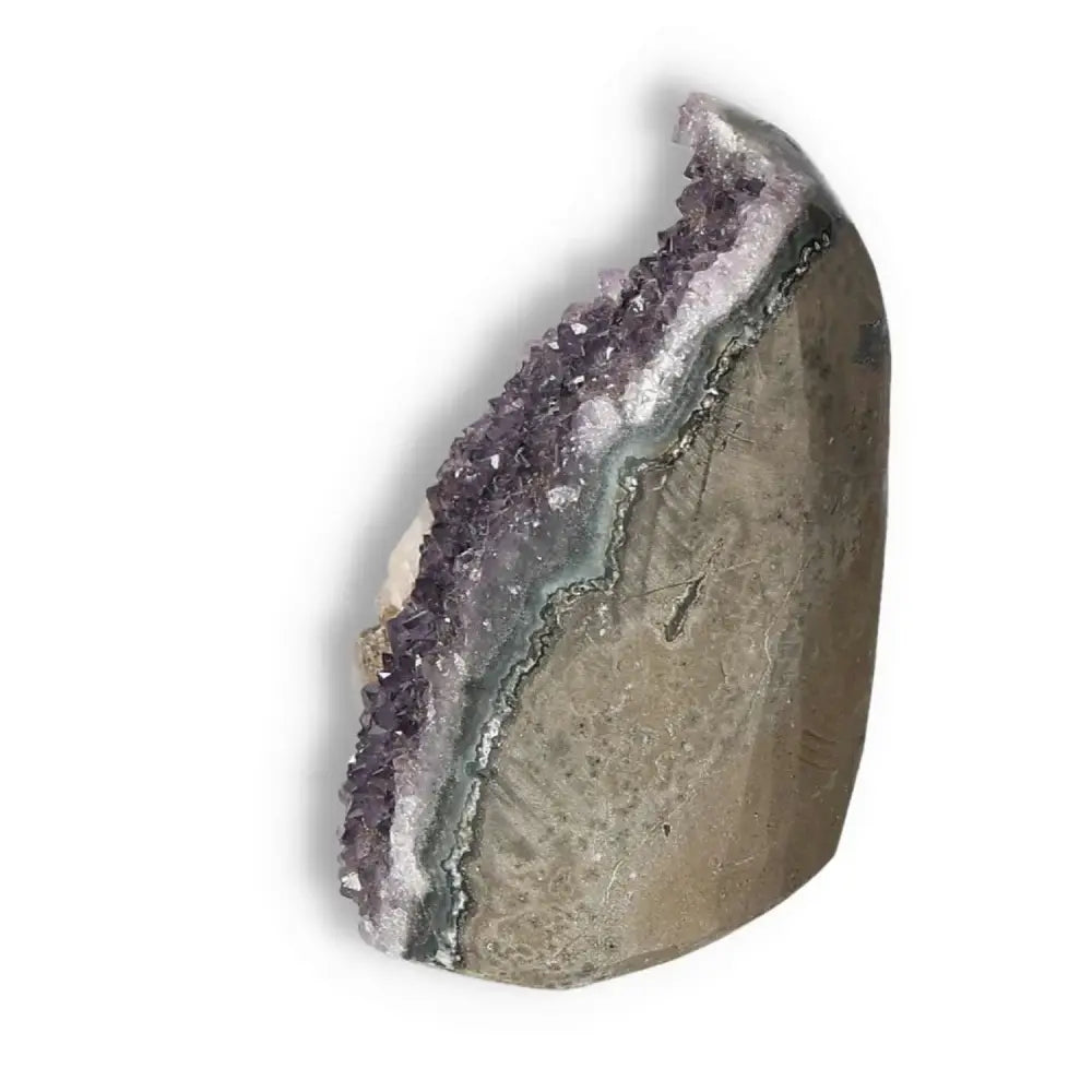 Amethyst cut base geode with purple crystalline structure, offering tranquility and balance, from Sylvia Crystals.