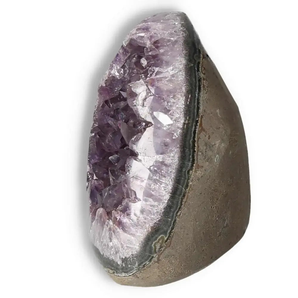 Amethyst cut base geode showcasing deep purple crystals, a luxurious offering from Sylvia Crystals for tranquility and space enhancement.