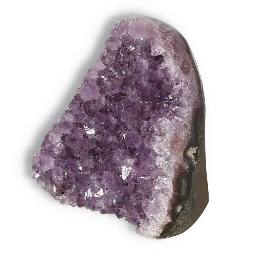 Amethyst cut base geode by Sylvia Crystals, showcasing luxurious purple hues and sparkling crystals for decoration and spiritual ambiance.