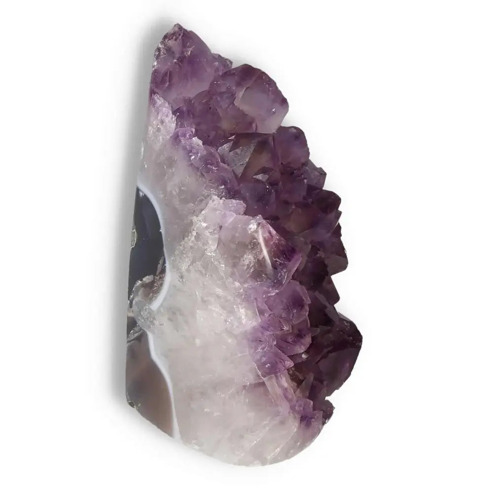 Amethyst cut base geode from Sylvia Crystals showcasing vibrant violet hues, renowned for stress relief and focus enhancement.
