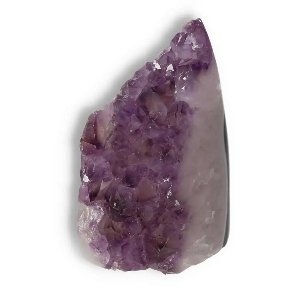 Amethyst cut base geode with deep violet hue, from Sylvia Crystals, known for stress relief and focus enhancement, showcased on white background.
