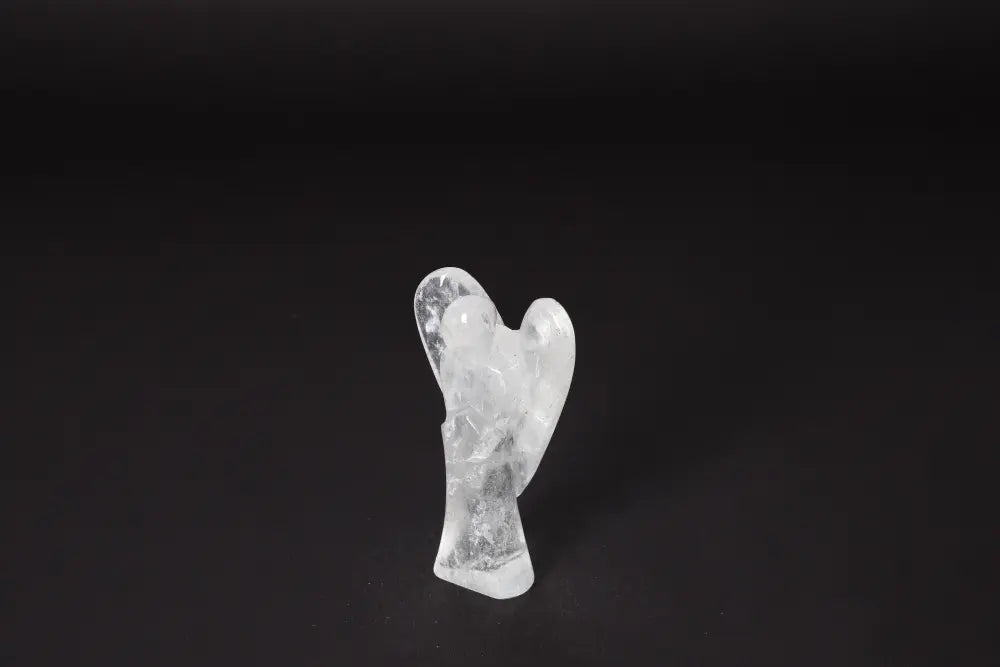 Angel Lemurian Quartz figurine on dark background, known for amethyst properties reducing stress, boosting energy, and enhancing concentration.