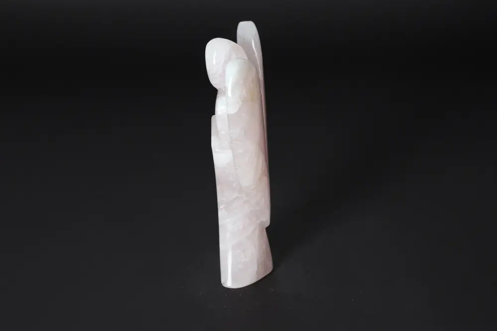 Rose Quartz angel figurine, 15 cm tall, standing upright on a black background. Ideal for harmonizing energy and purifying spaces.
