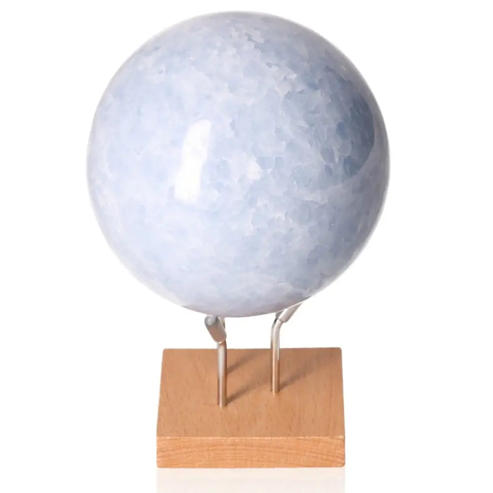 Blue Calcite Sphere on stand, serene gemstone known for calming, stress-relief, enhanced communication, and emotional balance benefits.