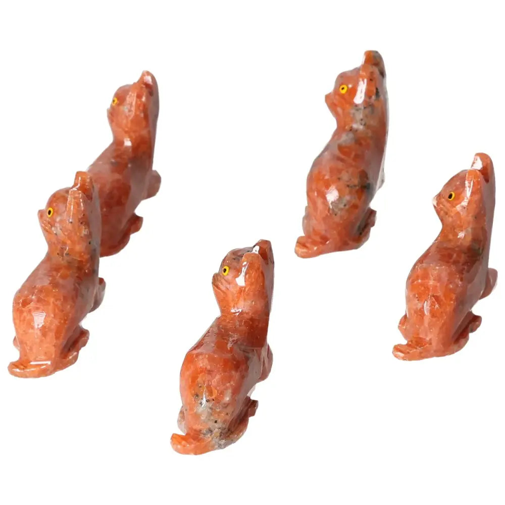 Group of carved dolomite cat figurines promoting tranquility and balance through natural artistry from Sylvia Crystals.