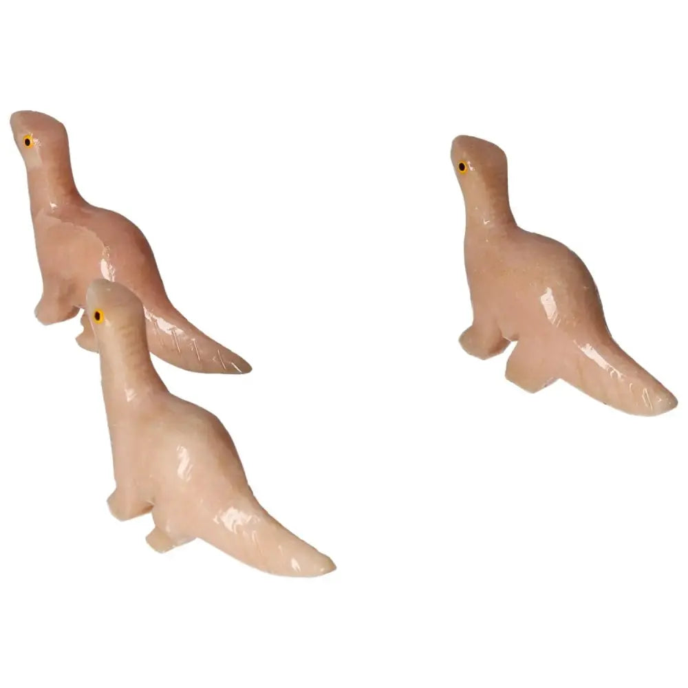 Carved Dolomite Dinosaur sculptures from Sylvia Crystals, showcasing exquisite detail and natural beauty; perfect for wellness and decor.