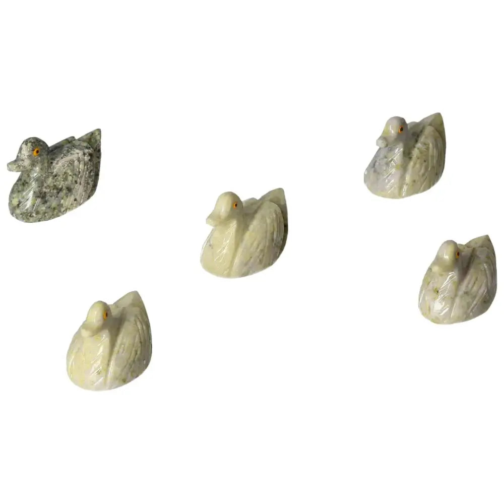 Collection of carved dolomite ducks, showcasing natural hues and unique markings, ideal for home decor and emotional balance.