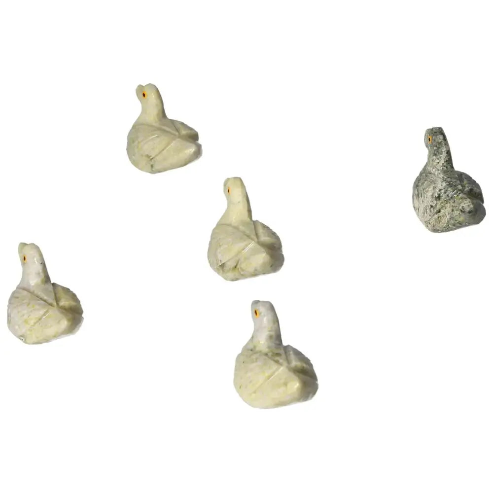 Collection of carved dolomite ducks showcasing serene and elegant designs for emotional balance and tranquility.