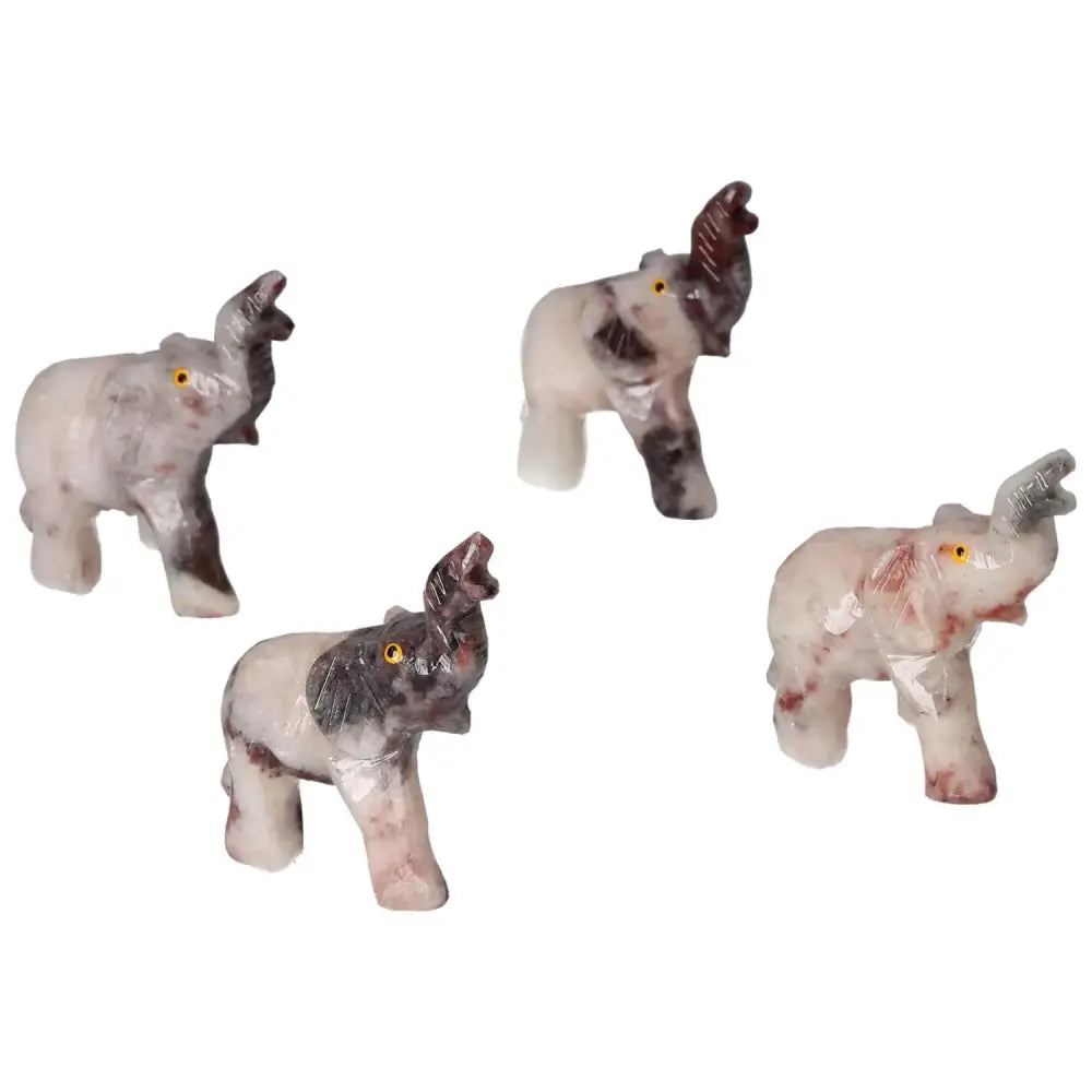 Four hand-carved dolomite elephants showcasing elegant craftsmanship and natural beauty; perfect for home or office decor.