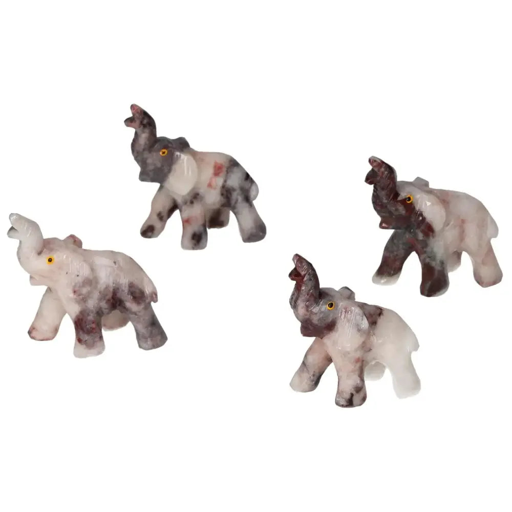 Four carved dolomite elephants from Sylvia Crystals showcasing exquisite craftsmanship and tranquil elegance.