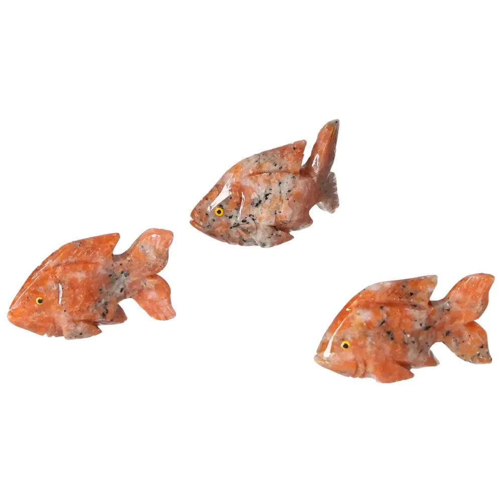 Three carved dolomite fish sculptures by Sylvia Crystals, showcasing fine craftsmanship and unique stone texture for harmonious decoration.