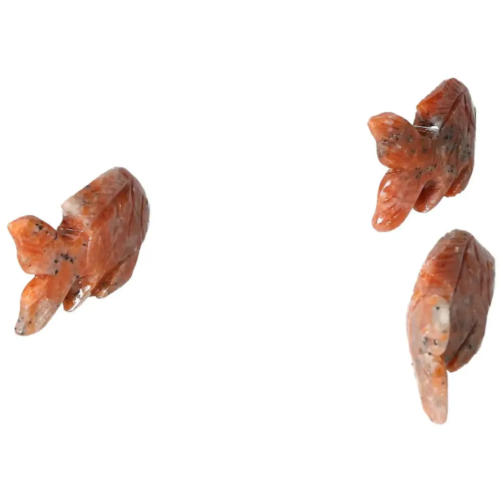 Three carved dolomite fish sculptures, showcasing intricate craftsmanship and natural patterns, designed to enhance decor and energy balance.