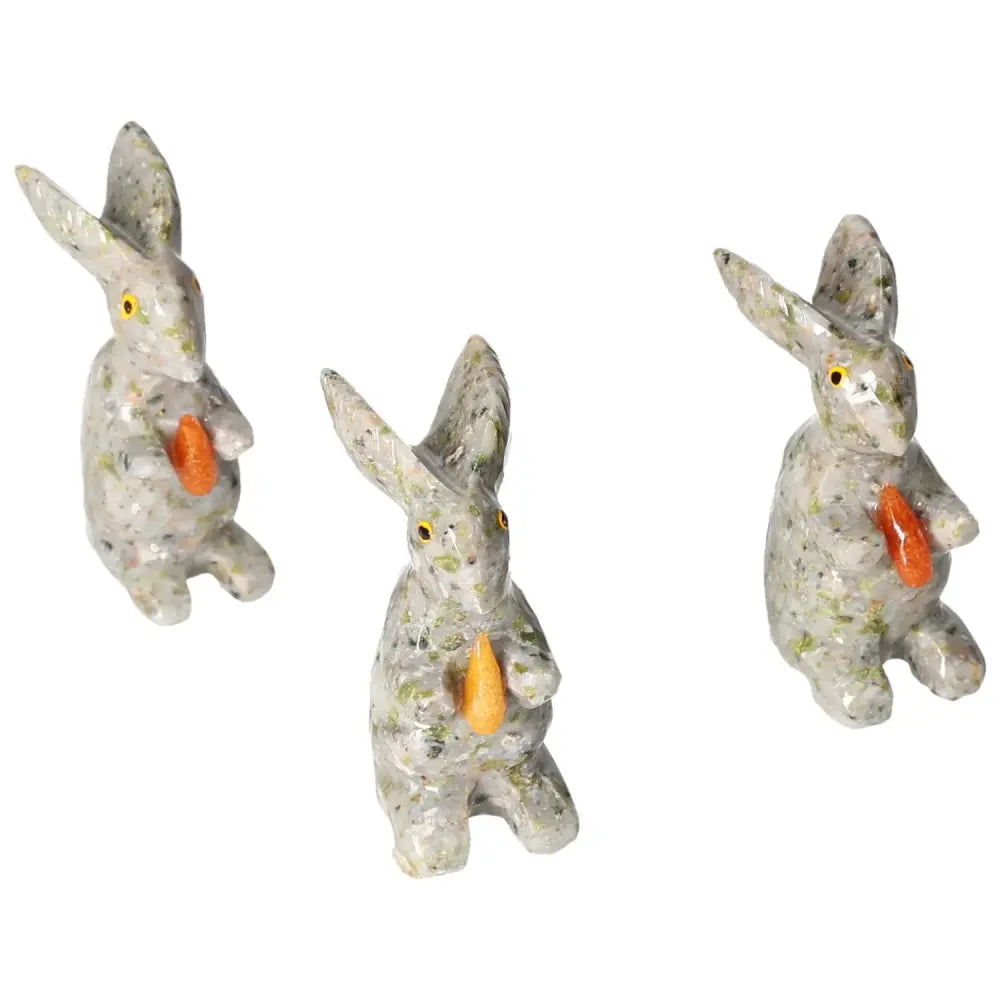 Three carved dolomite rabbit sculptures featuring elegant design and calming properties, by Sylvia Crystals.