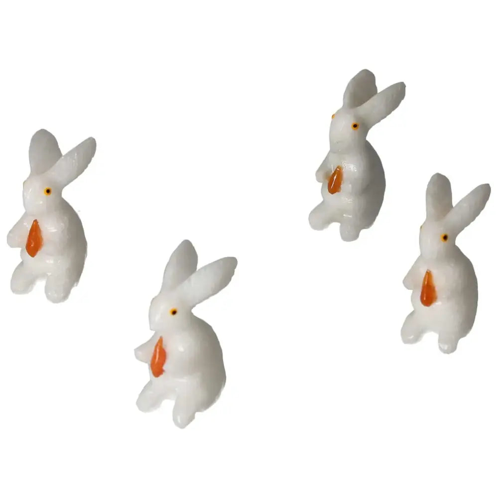 Four carved dolomite rabbit figures from Sylvia Crystals, enhancing spiritual balance and luxury decor.