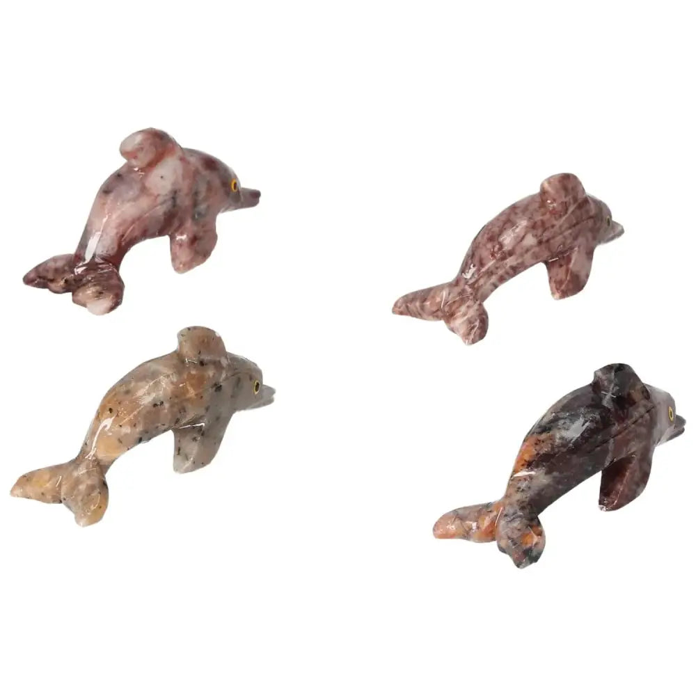 Four carved magnesite dolphin figurines from Sylvia Crystals, ideal for enhancing meditation spaces with elegance and spiritual significance.