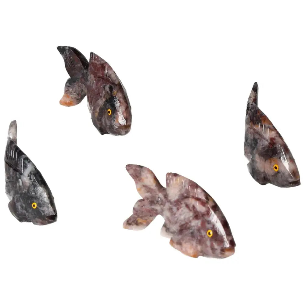 Hand-carved magnesite fish figures for meditation by Sylvia Crystals, promoting tranquility and creativity in a serene setting.