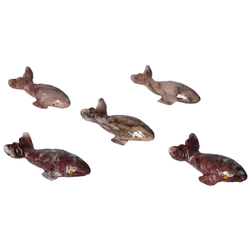 Collection of handcrafted carved magnesite whales, showcasing tranquility and inspiration with unique colors and patterns.