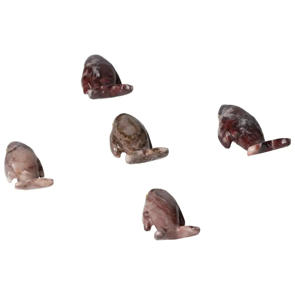 Five handcrafted Carved Magnesite Whales in various shades, symbolizing tranquility and elegance from Sylvia Crystals.