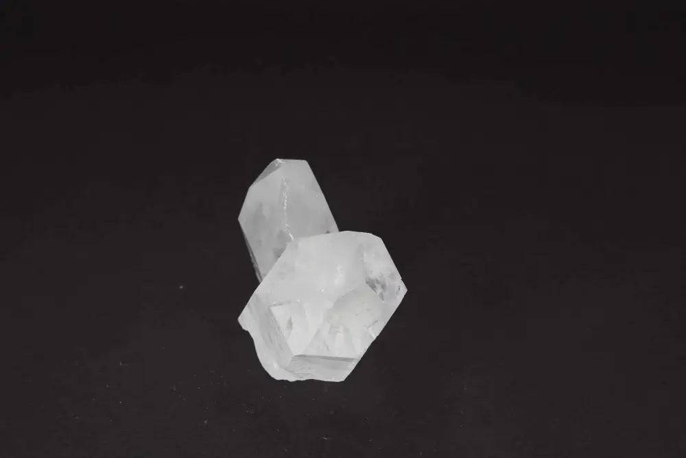 Clear Quartz Cluster on dark background, showcasing crystal points and radiant energy for purity and harmony in any space.