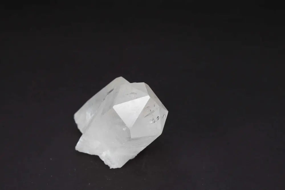 Clear Quartz Cluster - Natural crystal points on dark background, amplifying energy and intention, radiating purity and vibrational harmony.