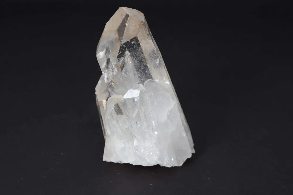 Clear Quartz Cluster displaying crystal points on black background, radiating pure energy and high vibrational clarity.