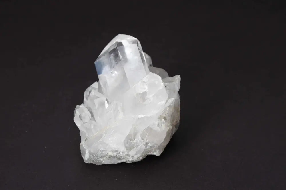 Clear Quartz Cluster on dark background showcasing multiple crystal points for amplifying pure energy and clarity in any space.