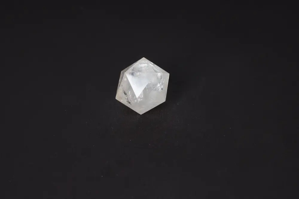 Clear Quartz Geometric Sphere 4 cm, a powerful stone for purification and harmonizing energy, displayed on a dark background.