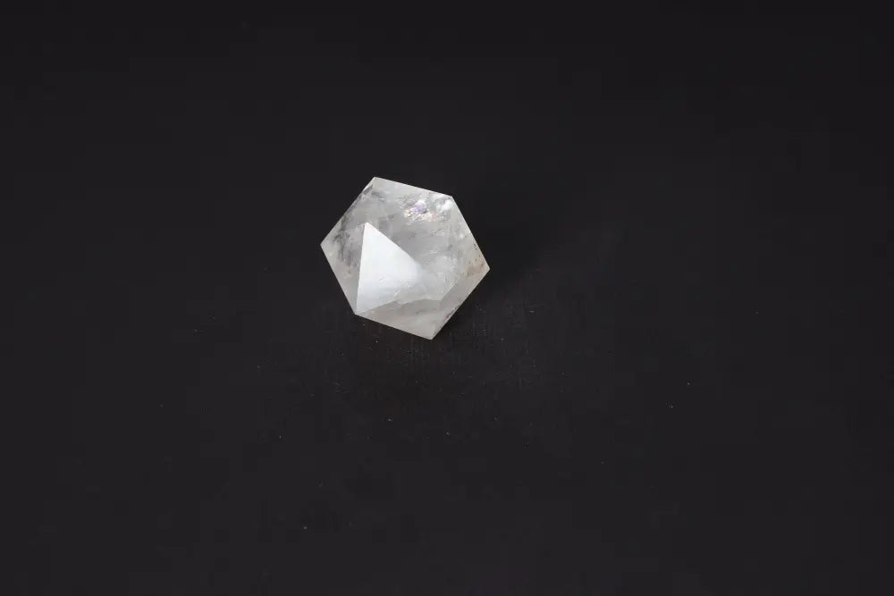 Clear Quartz Geometric Sphere 4 cm on dark background, known for purification, harmonizing energy and neutralizing negative vibrations.