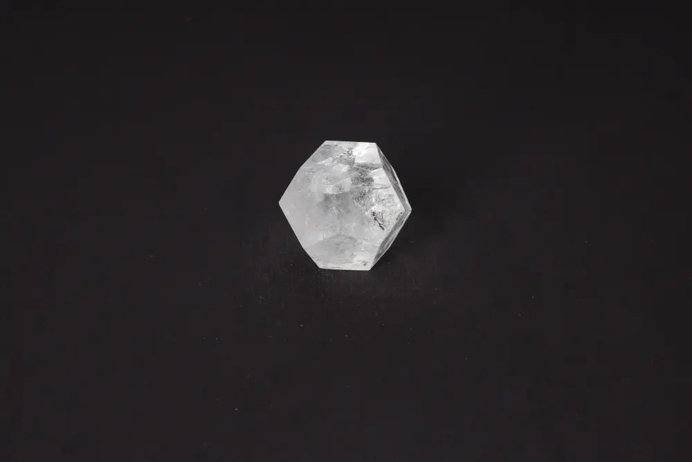 Clear Quartz Geometric Sphere 5 cm on black background, a stone known for purification and harmonizing energy, absorbing negative vibrations.