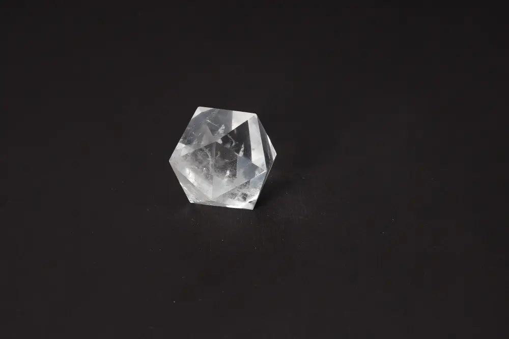 Clear Quartz Geometric Sphere 5 cm on black background for energy purification and harmonization.