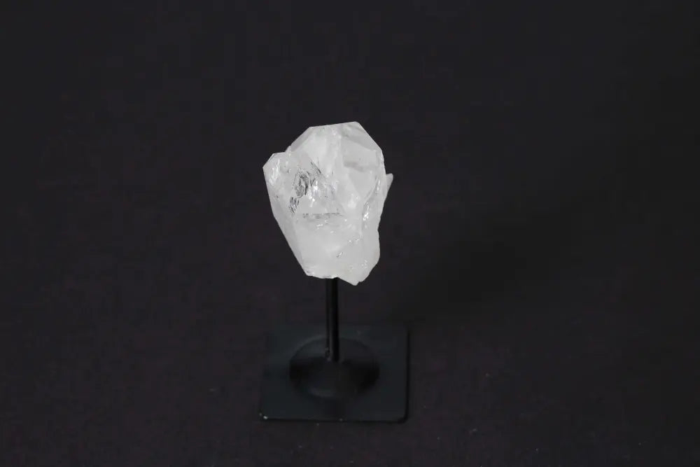 Clear Quartz on metal stand by Sylvia Crystals, highlighting luxury and spirituality with mental clarity benefits.