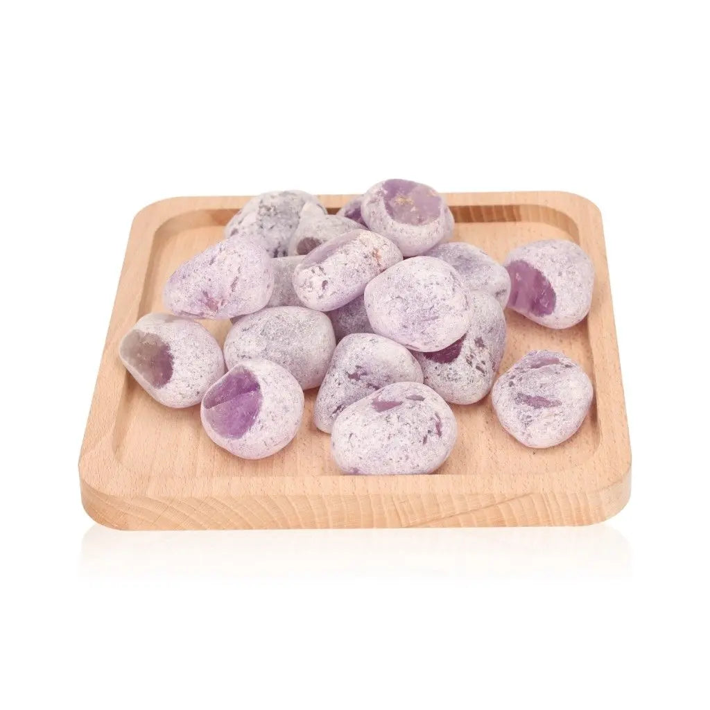 Emma Eggs, smooth and oval river stones, displayed on wooden tray, known for calming energy and natural polish from New Zealand rivers.