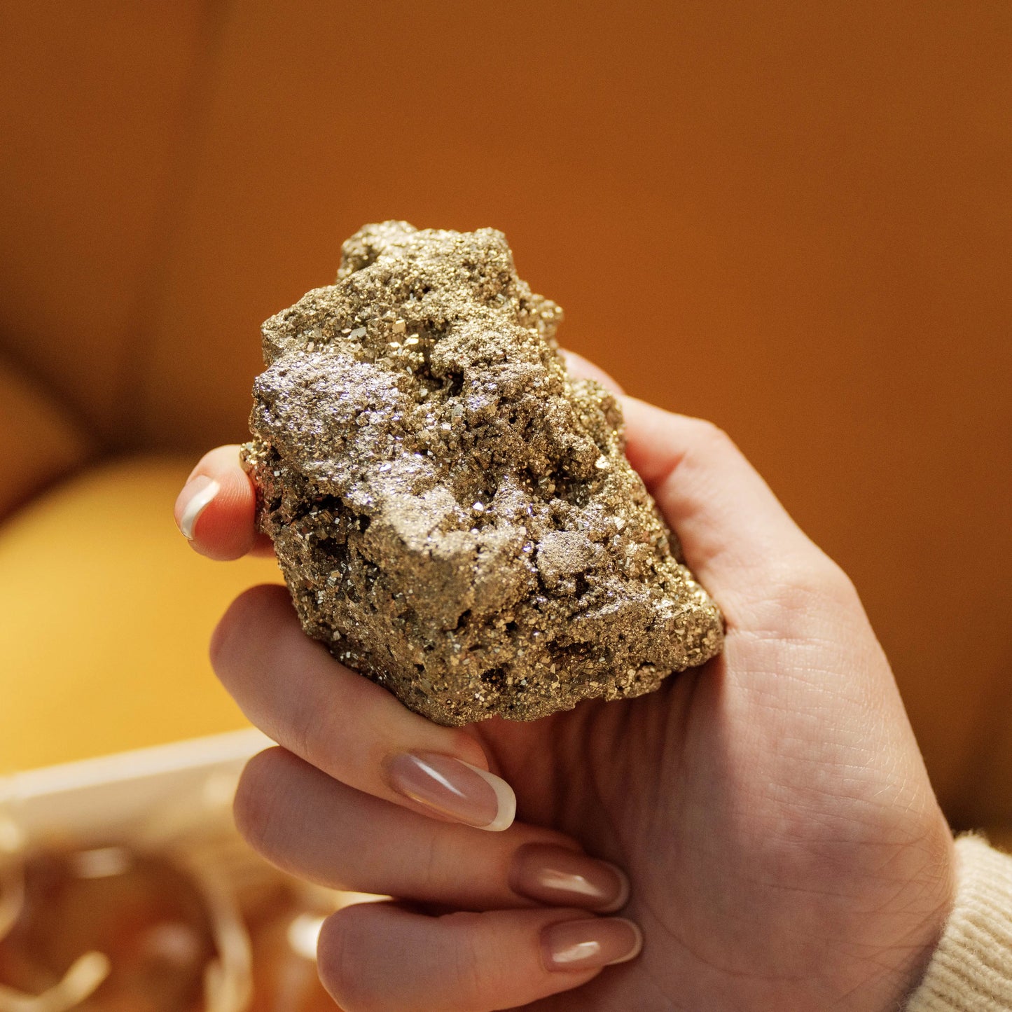 Hand holding a piece of rough pyrite from the Eternal Love Gift Box, perfect for energy cleansing and unique Valentine's Day gifts.
